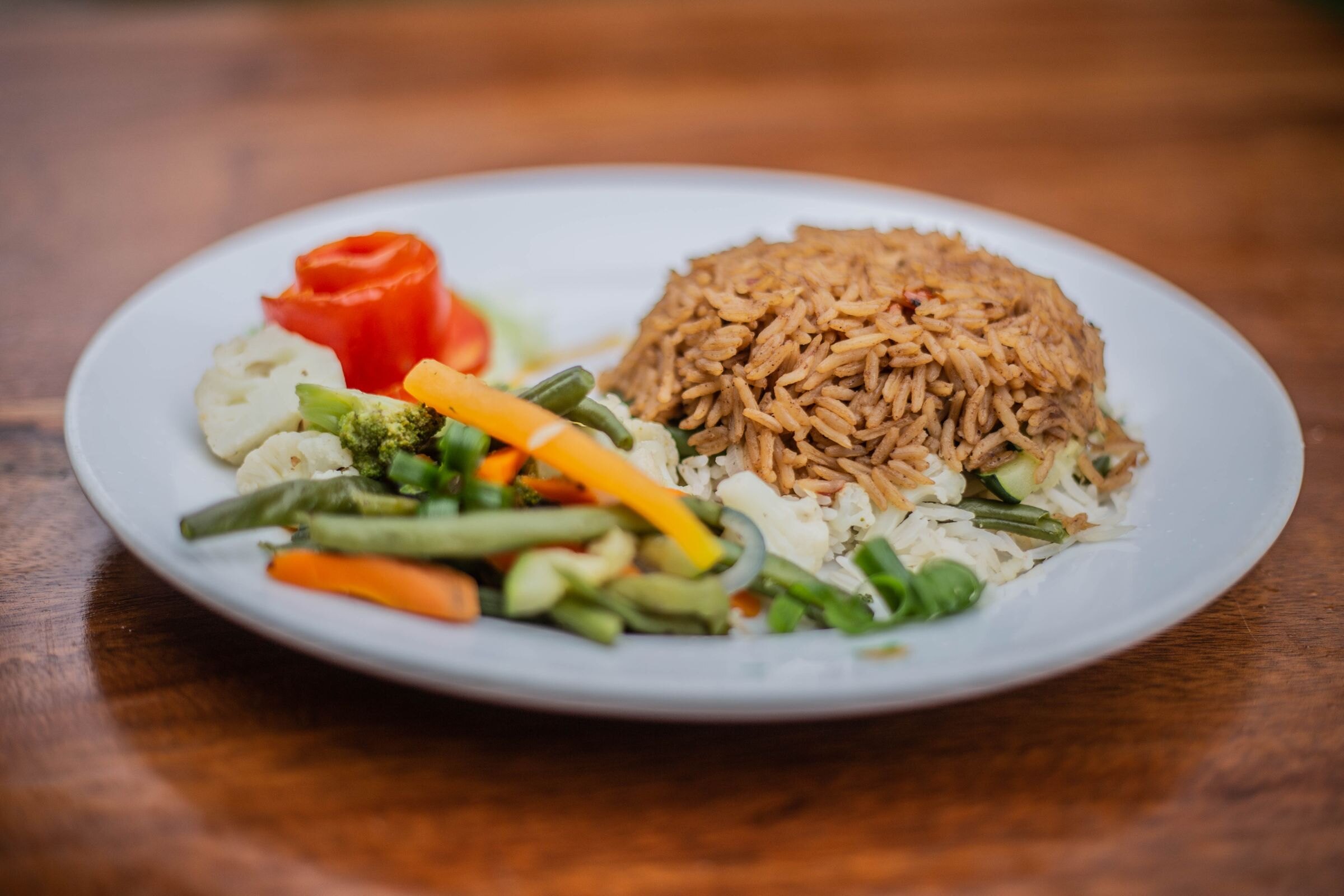 A plate of rice and steamed vegetables
