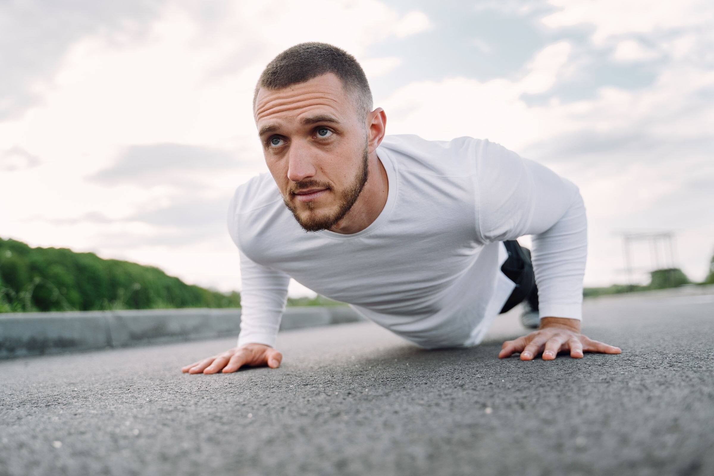 A man doing a push-up outdoors