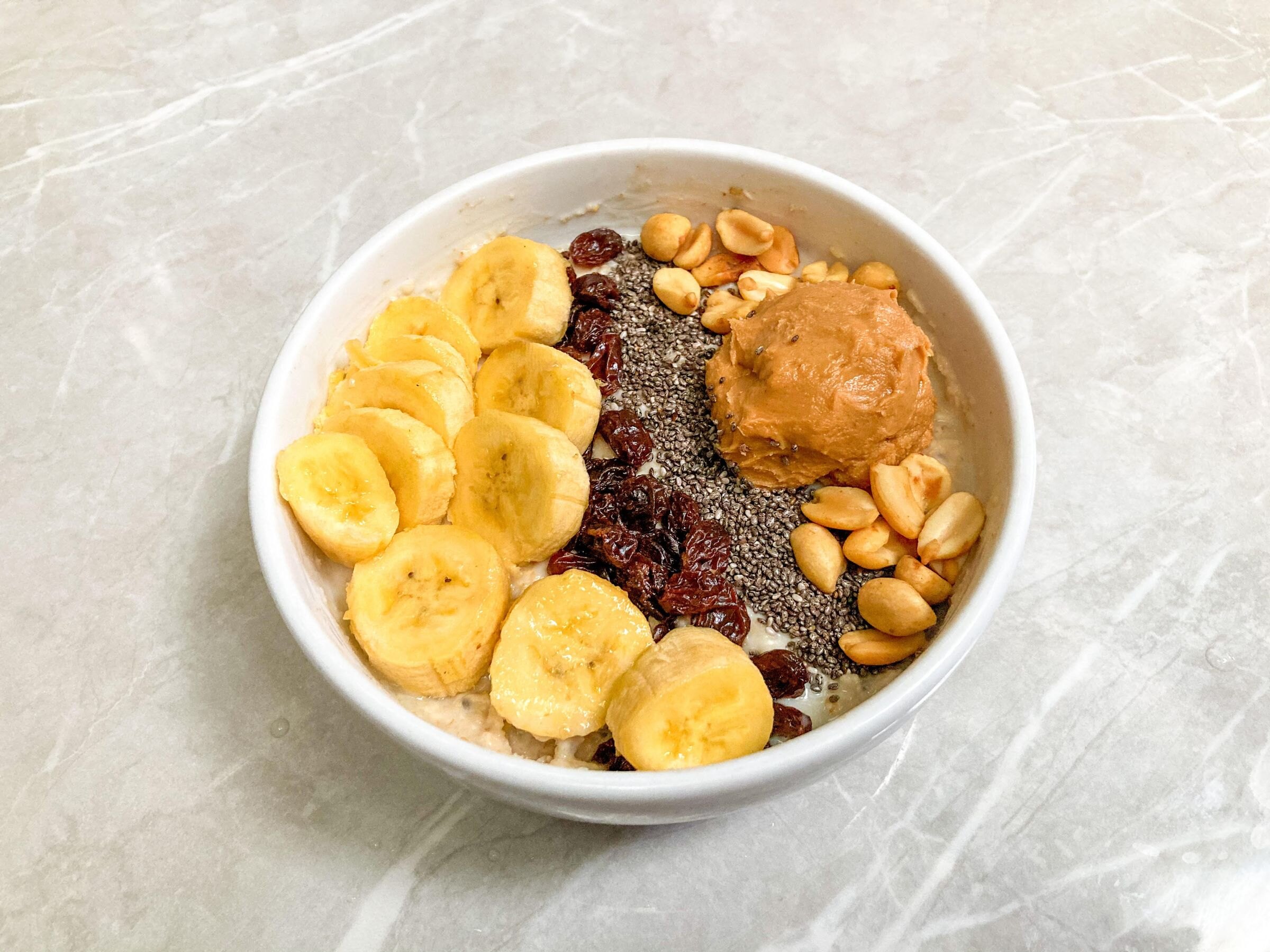 A bowl of oatmeal with banana and peanut butter