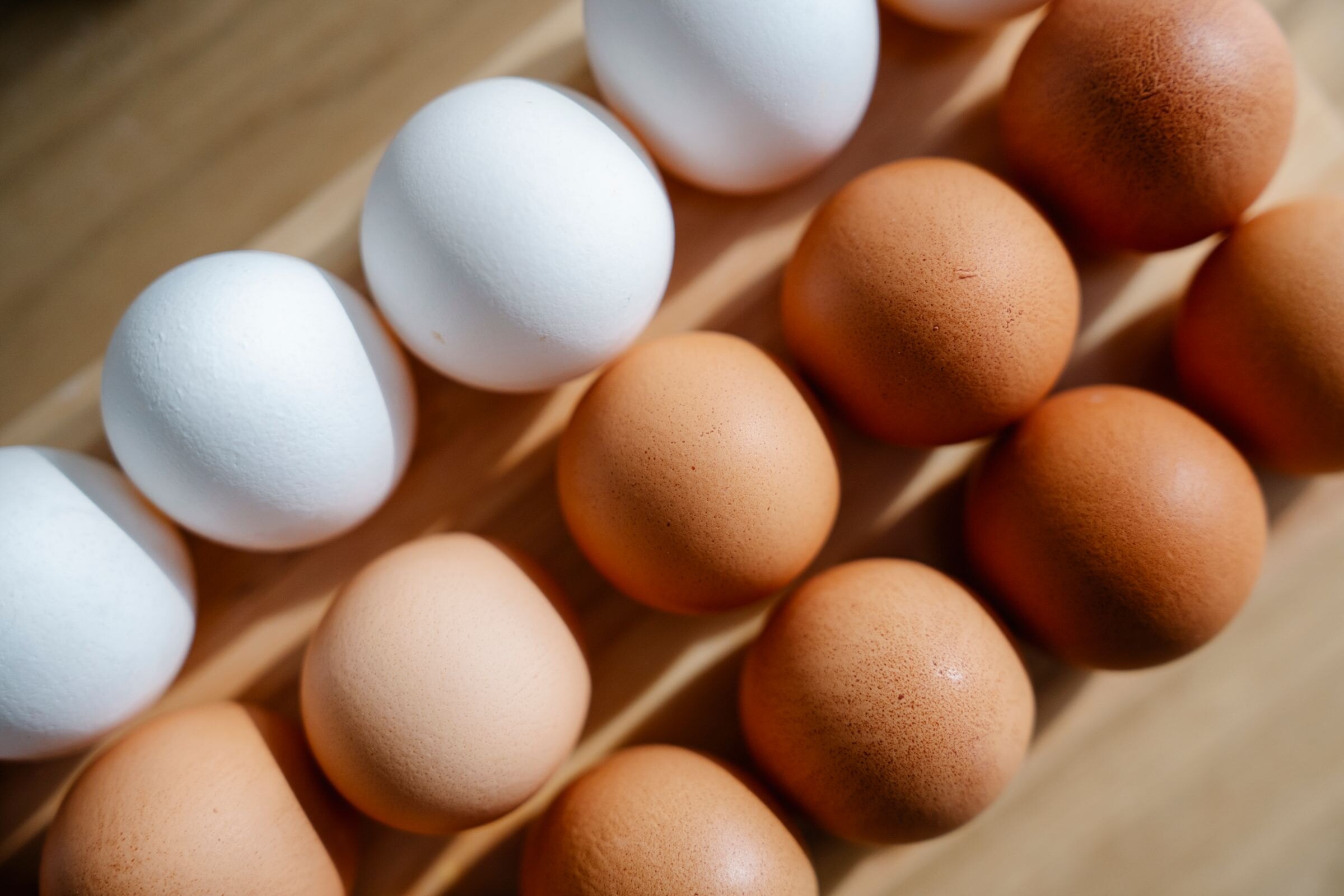 Brown and white eggs in a carton